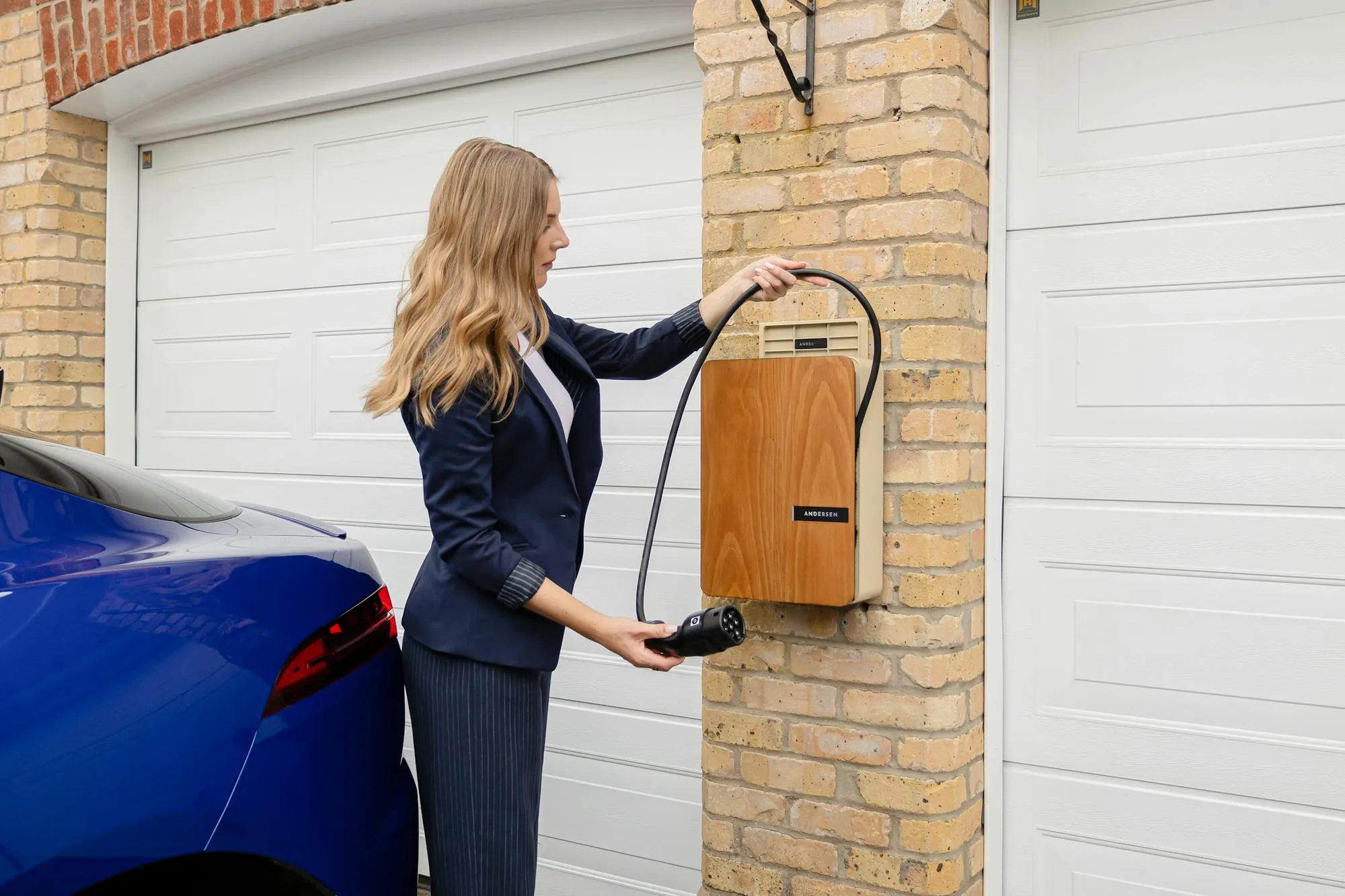 Home EV charger installed on a UK brick driveway wall